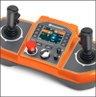 orange remote control with toggles on both sides and panel in the middle to run Husqvarna demolition robot