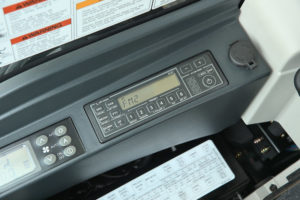 Pictured is a Kobelco SK260LC Long Reach Excavators stereo radio and power port, one of many great features in Kobelco Excavators.