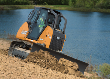 CASE crawler dozer pushing dirt at an angle with a pond in the background, available for rental and ideal for earth moving projects.