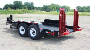 TowMaster Trailer parked in an open field with a backdrop of trees and a clear blue sky.