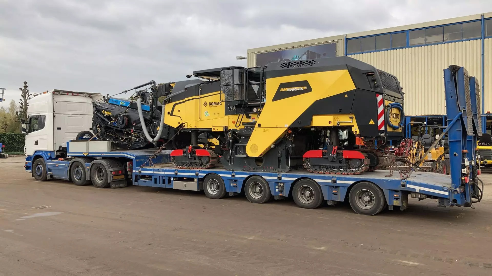 Bomag BM 2200 Milling Machine strapped to the bed of a transportation vehicle