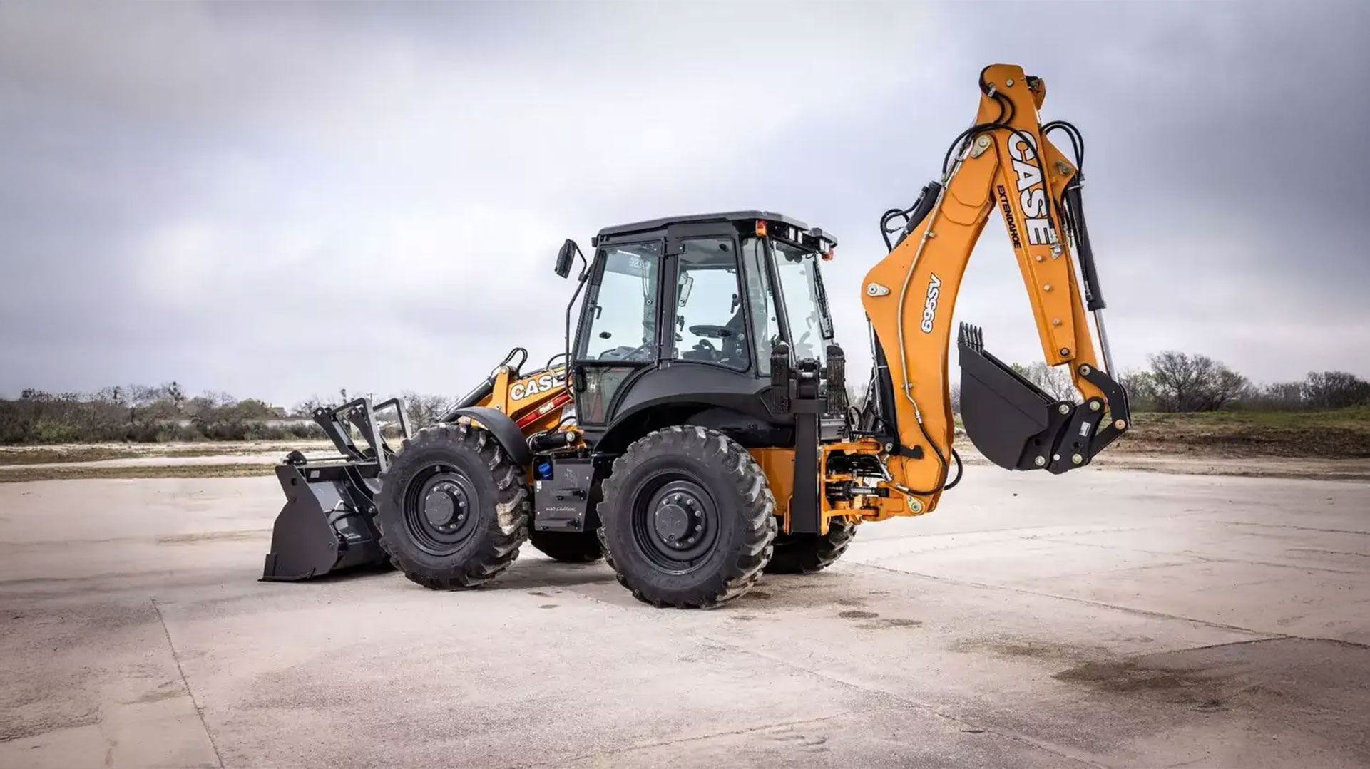 CASE 695SV parked on a concrete pad with cloudy skies