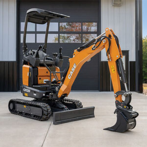 CASE CX12D Mini Excavator parked in front of a garage door, sitting on concrete