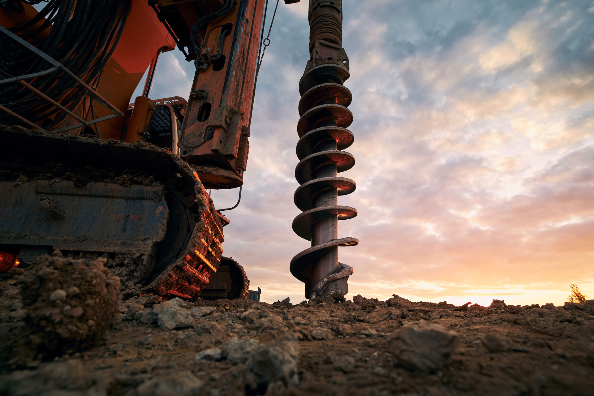 Building activity on construction site. Close-up view of drilling machine.