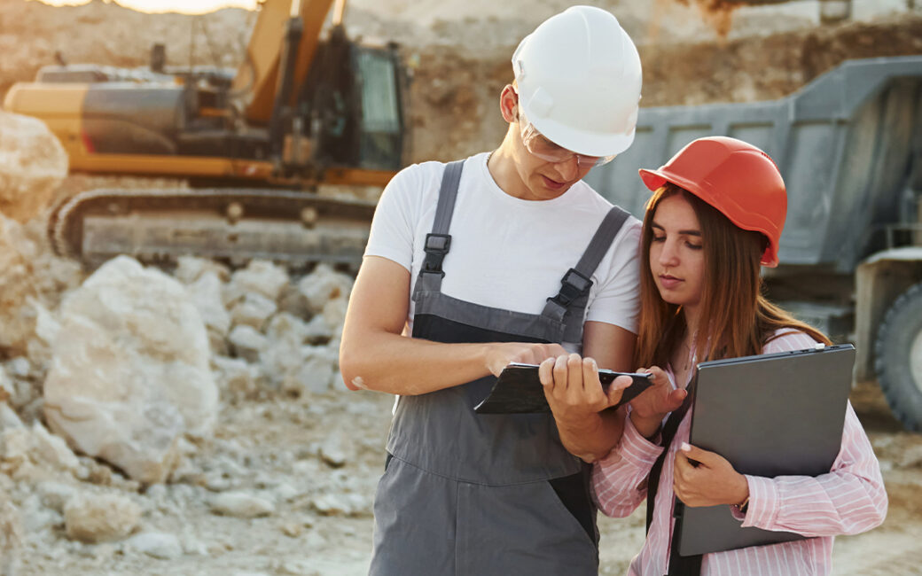 Two contractors look over construction plans/
