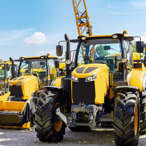 Yellow tractors and machinery at equipment dealership