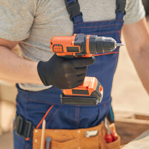 Construction Worker Holding Drill at Job Site