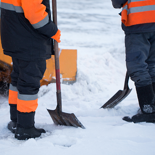 Construction workers with snow shovels