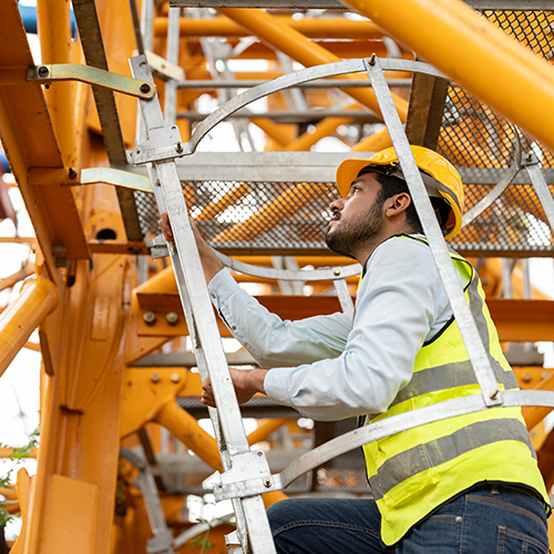 Construction worker climbing ladder